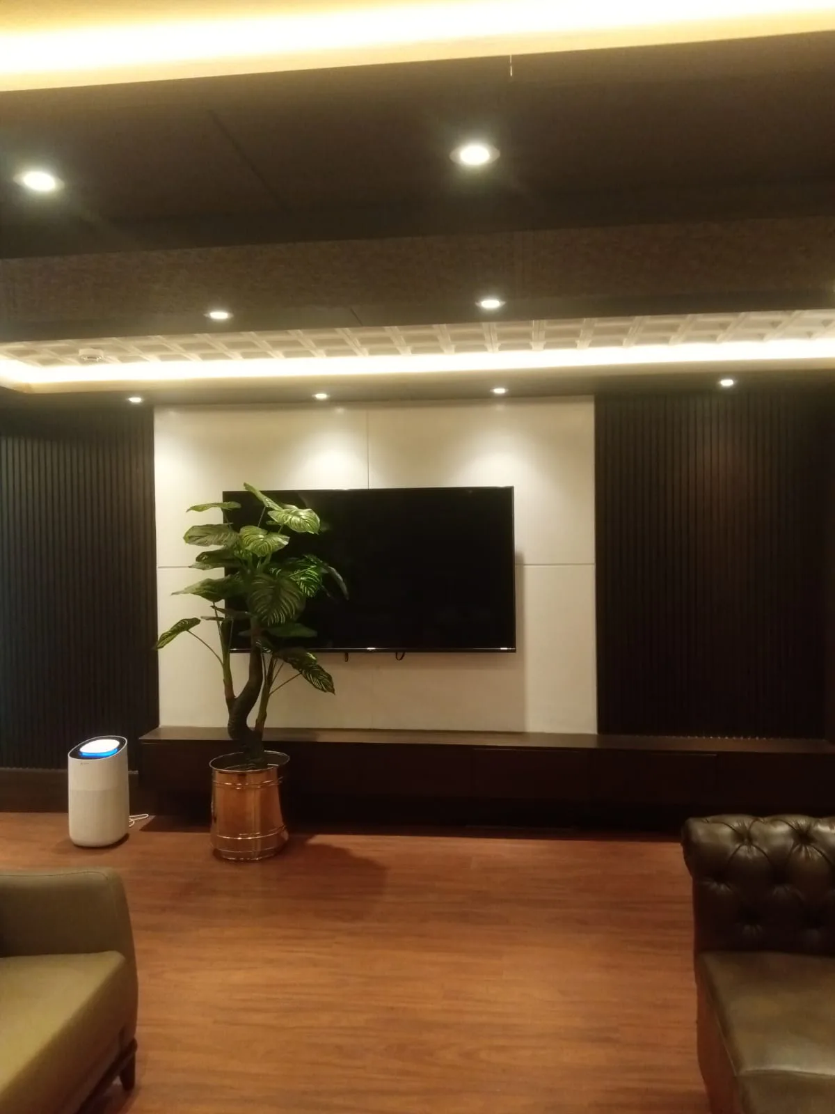 Finished media wall with fluted panels and concealed lighting